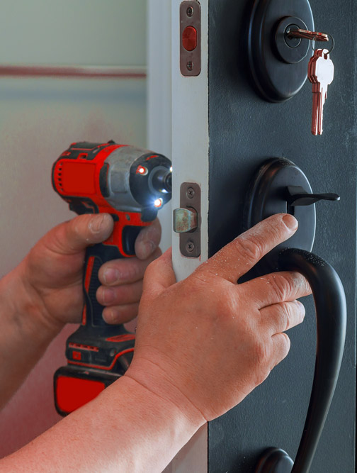 Residential locksmith installing a deadbolt
